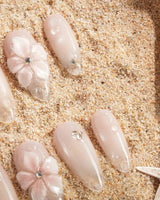 Blush Melt glossy nude pink nail set with cat-eye glow and floral gel texture