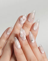 Blush Melt close-up of 3D translucent flowers on aurora nude press-on nails