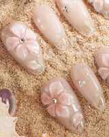 Blush Melt medium almond press-on nails with aurora nude cat-eye shimmer and translucent flowers