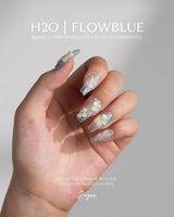 Bora Bora Blue custom-size nails with smoky blue shimmer and sculpted plumeria blossoms