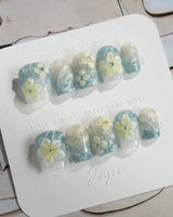 Bora Bora Blue extra short coffin nails with smoky blue cat-eye and floral accents