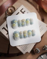 Bora Bora Blue short square nails with blue wave texture and raised plumeria flowers