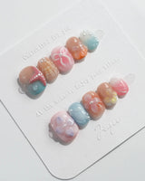 Candy Shore slow beach day nails with pastel shells, coral stars, and glossy florals