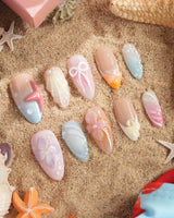 Candy Shore pastel ocean nails with coral starfish, seashells, and candy-toned florals