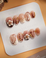 Caramel Cream nail close-up with raised flowers, warm brown tones, and glossy finish