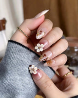Caramel Cream press-ons with glossy caramel tones, raised floral details, and metallic gold lines