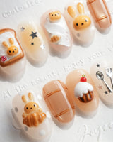 Caramel Miffy short oval nails with 3D bunny, toast, cupcakes, and warm caramel tones