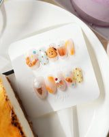 Caramel Toast glossy nail art with 3D pastry charms and playful bakery colors