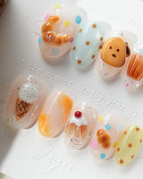 Caramel Toast bakery press-on nails in honey brown, butter yellow, baby blue, and cream