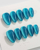 Blue Sky Cat-eye press-on nails in extra short almond shape — Peacock Blue cat eye