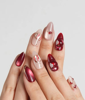 Sweet Bite handmade press-on nails featuring Deep Red & Nude Pink, Cat-eye Finish, Hand-painted Red Hearts & Metallic Lines.