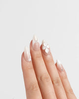 Ceramic press-on nails in short almond shape — Classic Nude Pink Ombré, 3D White Florals & Minimalist Rhinestones.