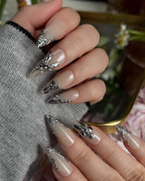 Chrome Rebellion handmade press-on nails featuring Nude, 3D Silver Butterflies & Liquid Metal.
