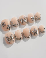 Chrome Rebellion press-on nails in extra short squoval shape — Nude, 3D Silver Butterflies & Liquid Metal.