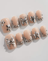 Chrome Rebellion press-on nails in short square shape — Nude, 3D Silver Butterflies & Liquid Metal.