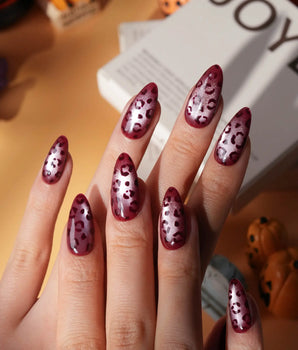 Claret leopard cat eye press on nails, deep wine red base with a rose gold shimmer band and hand-painted black leopard spots - image 1