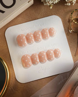 Cloud Cream press-on nails — Peach Nude, Sweet White Polka Dots. handmade nail art by Joyee Nails