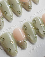 Clover Field press-on nails in short almond shape — Fresh Grass Green, Hand-painted Metallic Florals & French Pearl Outlines.