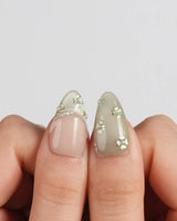 Clover Field press-on nails in short almond shape — Fresh Grass Green, Hand-painted Metallic Florals & French Pearl Outlines.