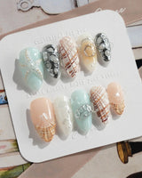 Coastline Edit press-on nails with pearly shell art and silver coastal details