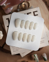 Coco Water handmade press-on nails featuring Milky Jelly White, Minimalist Silver cat eye French Tips.