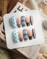 Cocoa Dot medium coffin press-on nails with chocolate brown and baby blue dot pattern