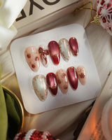 Coquette Red press-on nails with red chrome, nude accents, gold outlines and bow details