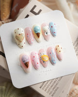 Cream Scoop short almond press-on nails with pastel pink base and dessert charms