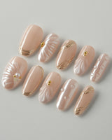 Venus luxury shell press-on nails with nude pearl base and metallic gold