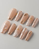Venus pearly nude custom press-on nail set with shell and gold accents