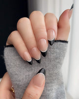 Close-up of Classic Return - Ebony with black French tips and fine white line detail
