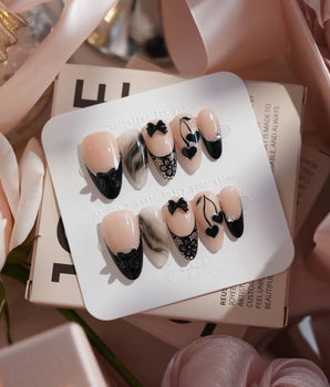 Dark Cherry handmade press-on nails featuring Chic Black & Nude, Lace Bows, Ink Marble Swirls & Glitter Heart Cherries.