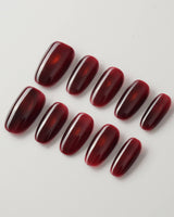 Deep Red Cat eye Nails press-on nails in medium oval shape — red cat eye christmas holiday