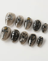 Devil Charm press-on nails in extra short almond shape — Sheer Black Gothic, 3D Skull & Dark Aesthetic.