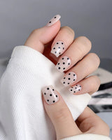 Dot Noir-Mini press-ons with glossy nude base, black accents, and dotted vintage styling