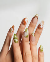 Double Latte glossy coffee and matcha nails with understated marbled patterns