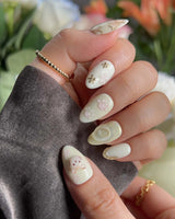 Double Love nail art close-up showing Creamy White Cute Healing, 3D Cats & Golden Flowers. details