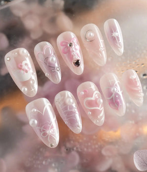 Dreamglow handmade press-on nails featuring Pearly Pink, 3D Bows & Pearls.