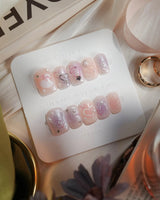 Dreamglow extra short square nails with pearly pink bows and delicate pearl accents