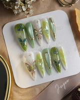 Dreamland short almond press-on nails with magical green gradient and chrome accents