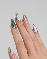 Electric Muse press-on nails with emerald cat-eye marble, nude base and glossy gold linework