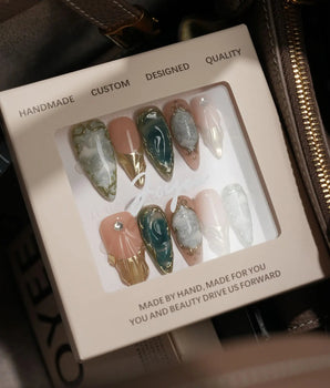 Electric Muse handmade press-on nails featuring emerald green cat eye marble gold frame nude base 3D sculpted glossy