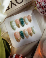 Electric Muse press-on nails with frosted blue-green marble, nude base and metallic gold details
