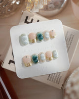 Electric Muse extra short squoval press-on nails with emerald cat-eye marble and gold frames