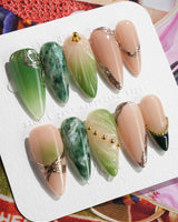 Emerald - Jade Sutra press-on nails in medium stiletto shape — Elegant Grape Green, Marble Smudge & Liquid Metal.