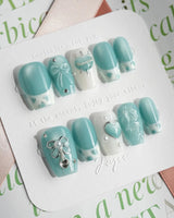 Exuma Blue short coffin nails with light blue ripples, 3D hearts, and glossy finish