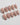 Glossy nude nails with cherry blossom petal design