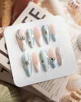 FIFA Argentina medium stiletto nails with elegant soccer theme and golden sun motifs