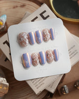 Flower Sea press-on nails in short oval shape — Lavender chrome and Hand-painted White Florals