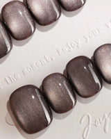 Fume handmade press-on nails featuring taupe brown cat eye